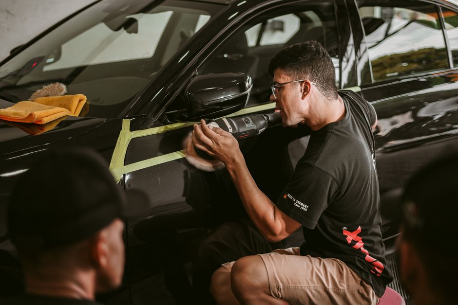 Professional auto detailer meticulously cleaning a vehicle